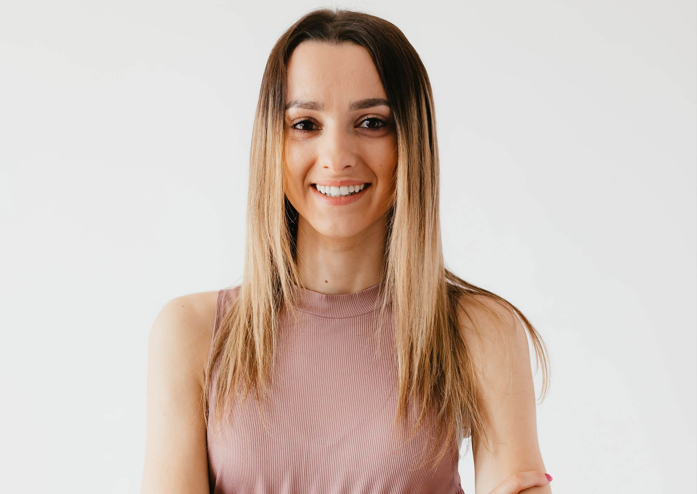Woman smiling Smiling woman in sleeveless mauve top