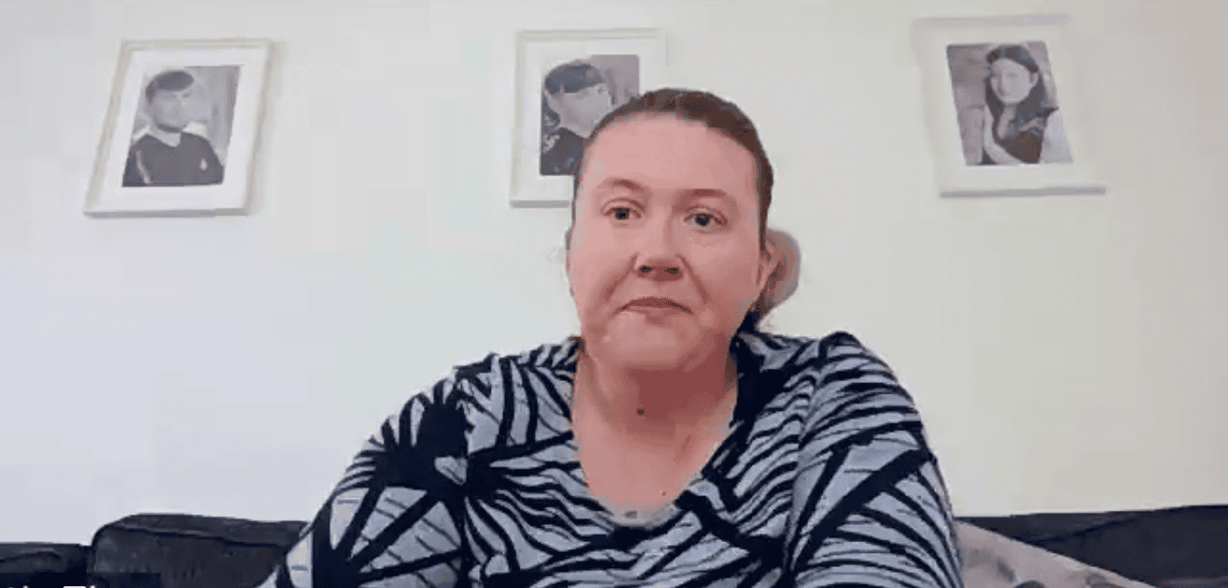 Woman with framed photos on the wall