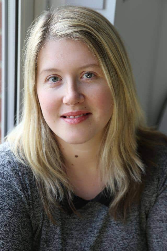 Woman with blonde hair by a window