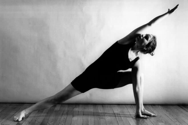 Woman performing yoga stretch pose indoors